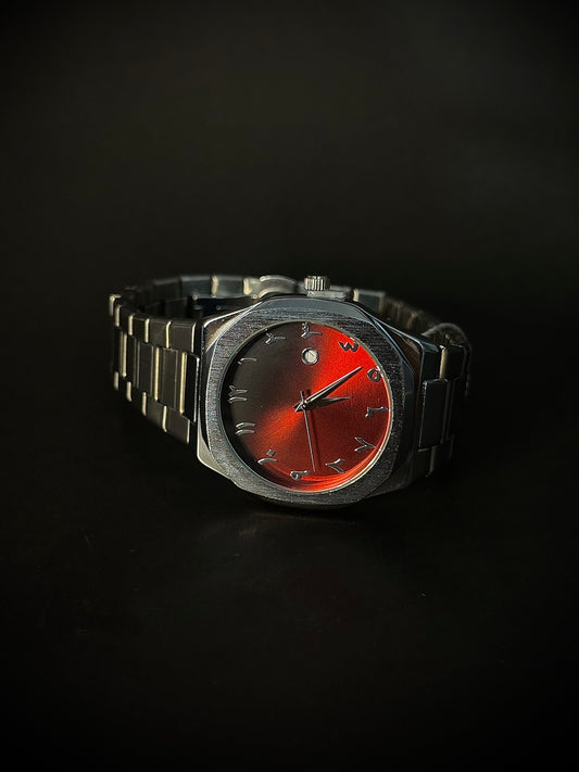 Wristwatch with a red face and metallic band on a black background